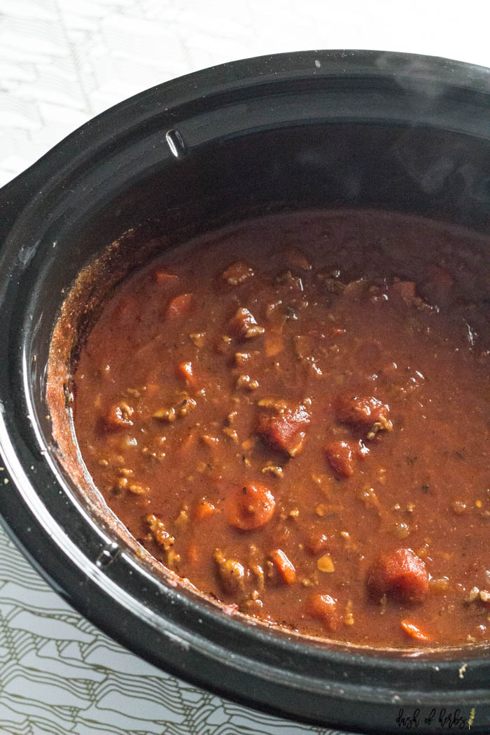 An image of the Slow Cooker Spaghetti Sauce recipe in the slow cooker. You can see the meat, carrots and tomatoes in the picture.