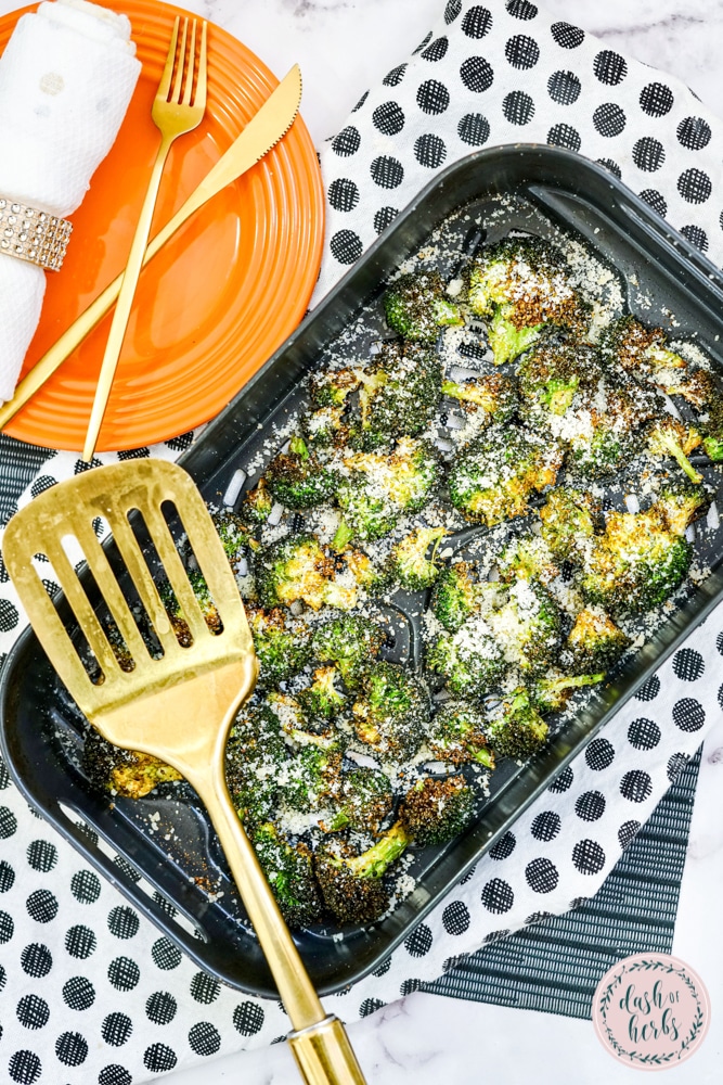 An overhead image of air fryer garlic parmesan broccoli still in the air fryer pan.